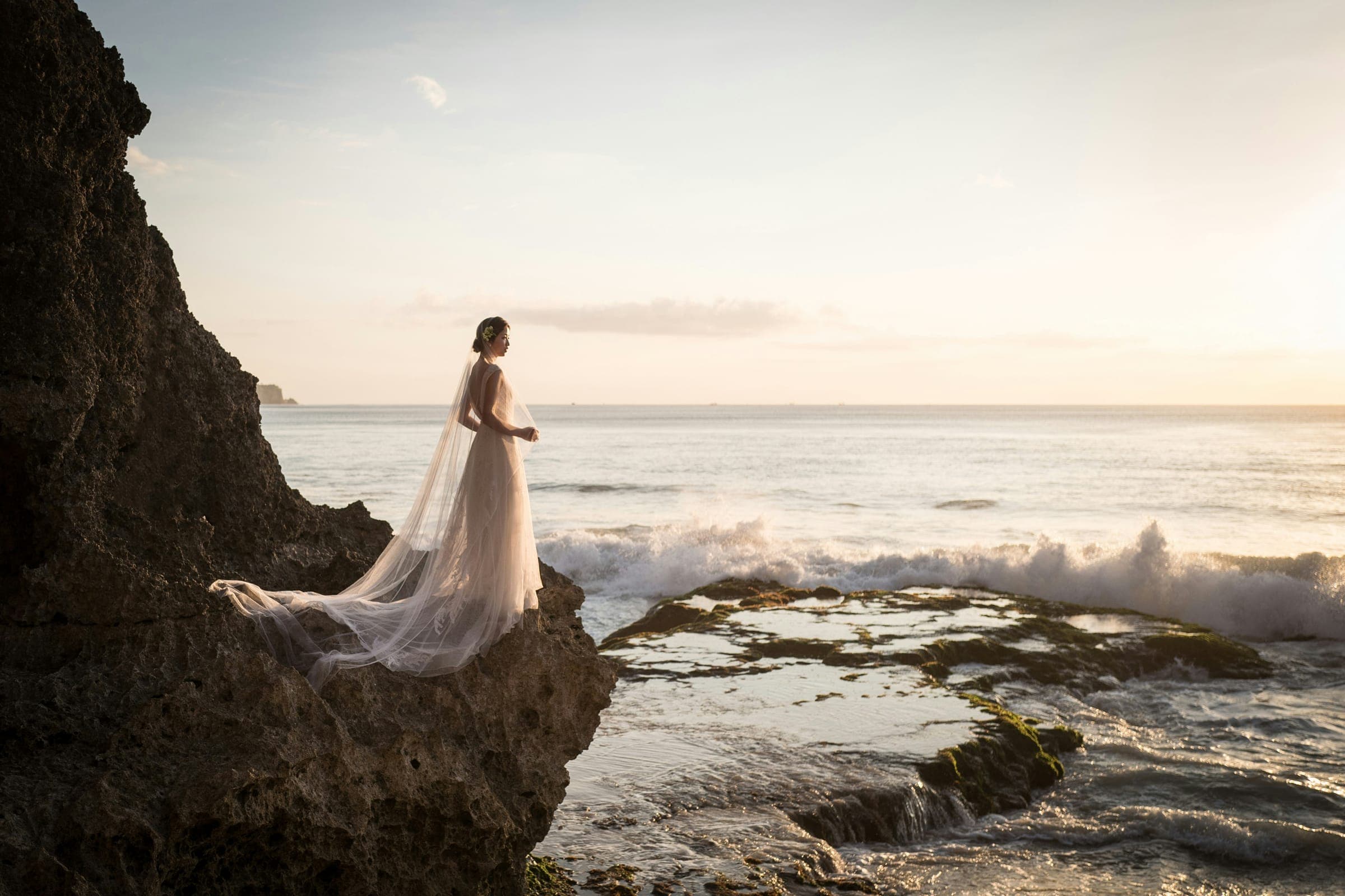 A couple by the coast on their wedding day